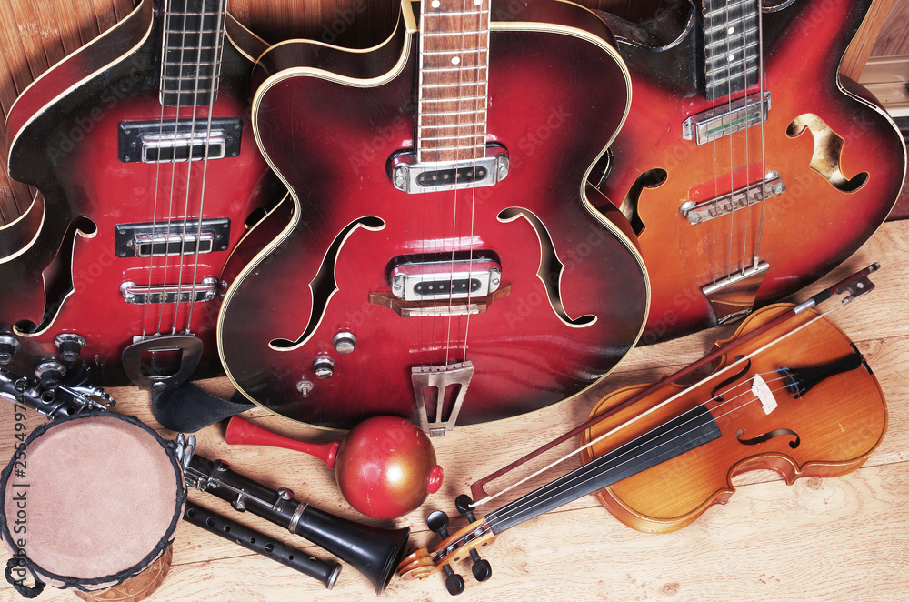 Naklejka premium Three electric guitars, violin, maracas, djembe
