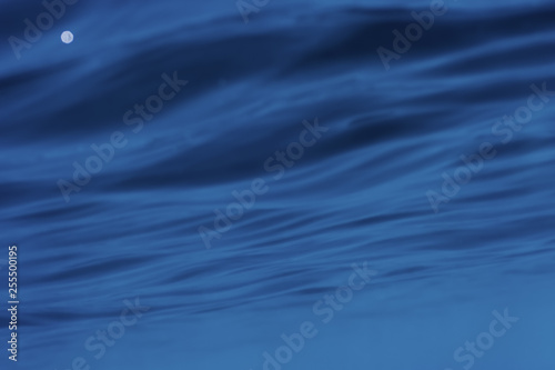 Underwater photograph of abstract ripples on sea surface.