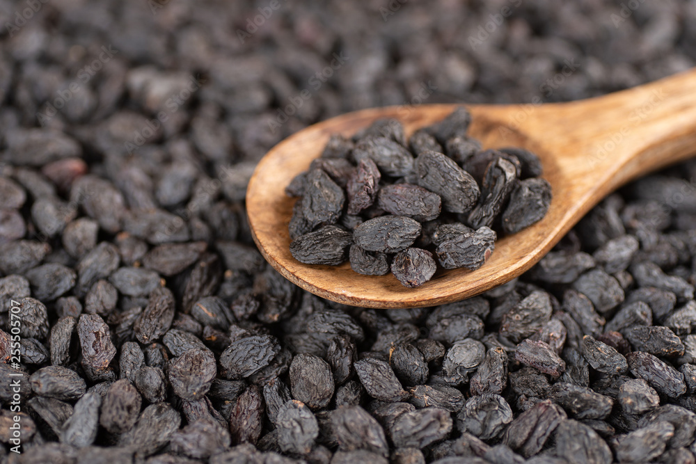 Wooden spoon with raisins. Selective focus. 