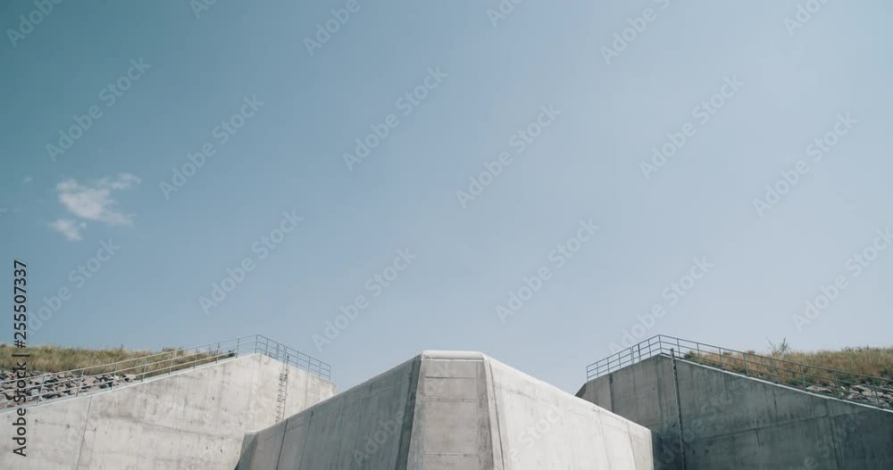 Dry concrete dam at western reservoir showing low water level Dry concrete dam at western reservoir showing low water level