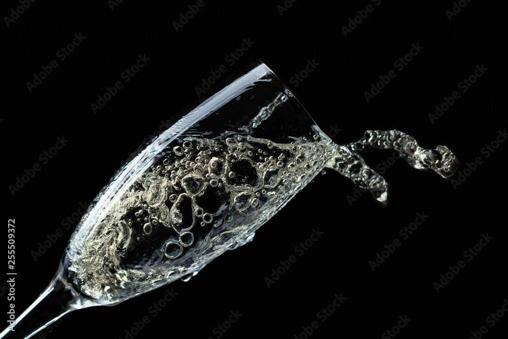 Splashing champagne on black background. Splashing champagne on black background.