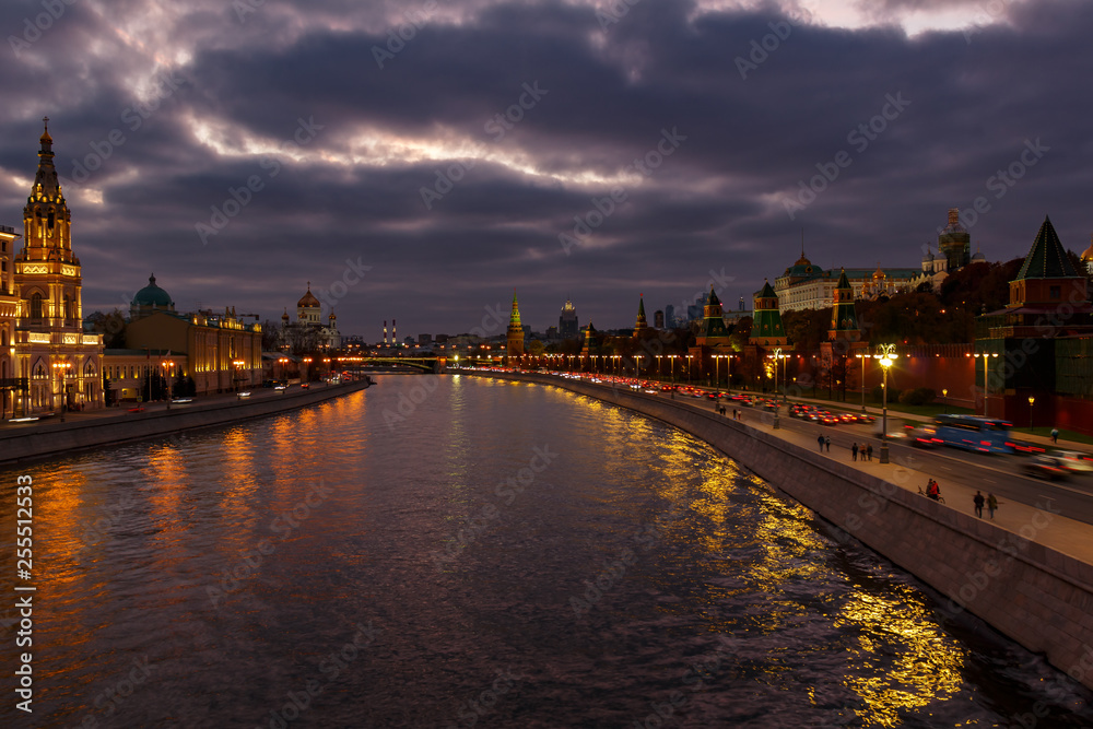 View of Moscow Kremlin and Moskva river embankments in evening against cloudy sky