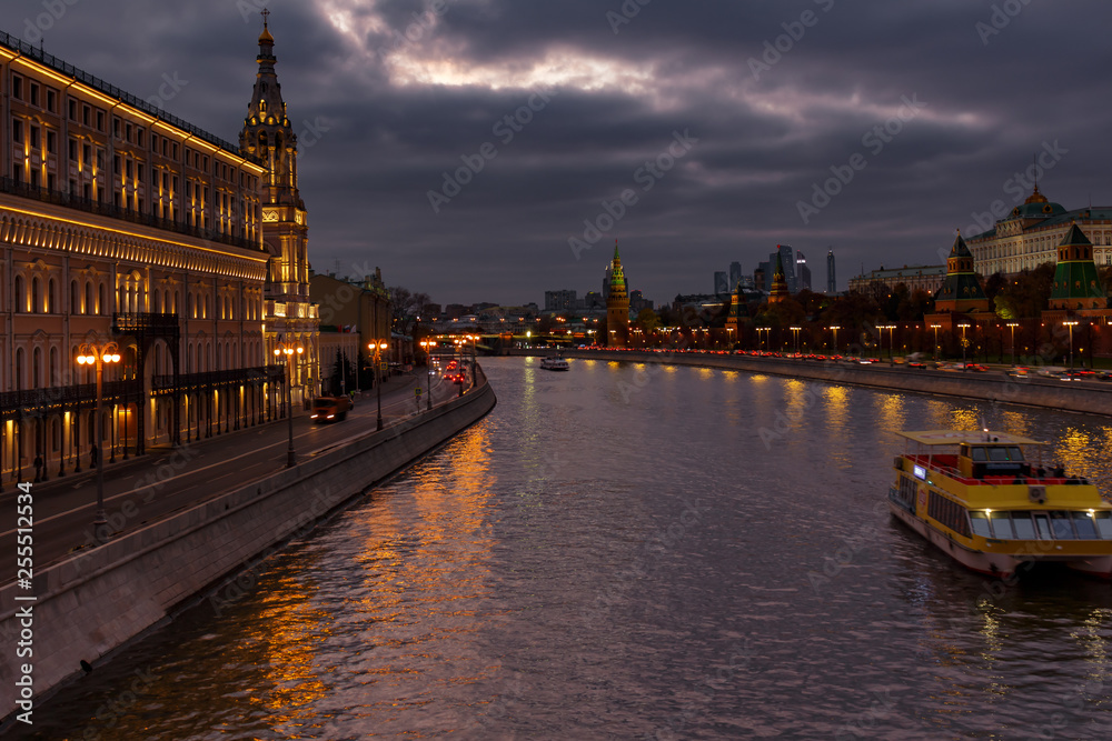 Moskva river embankments on a background of dramatic cloudy sky in evening. Moscow landscape