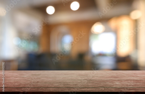 Empty wooden table in front of abstract blurred background of restaurant  cafe and coffee shop interior. can be used for display or montage your products - Image.