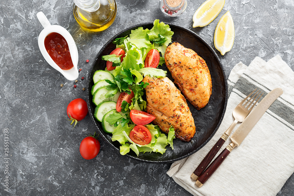 Grilled chicken breast. Fried chicken fillet and fresh vegetable salad .