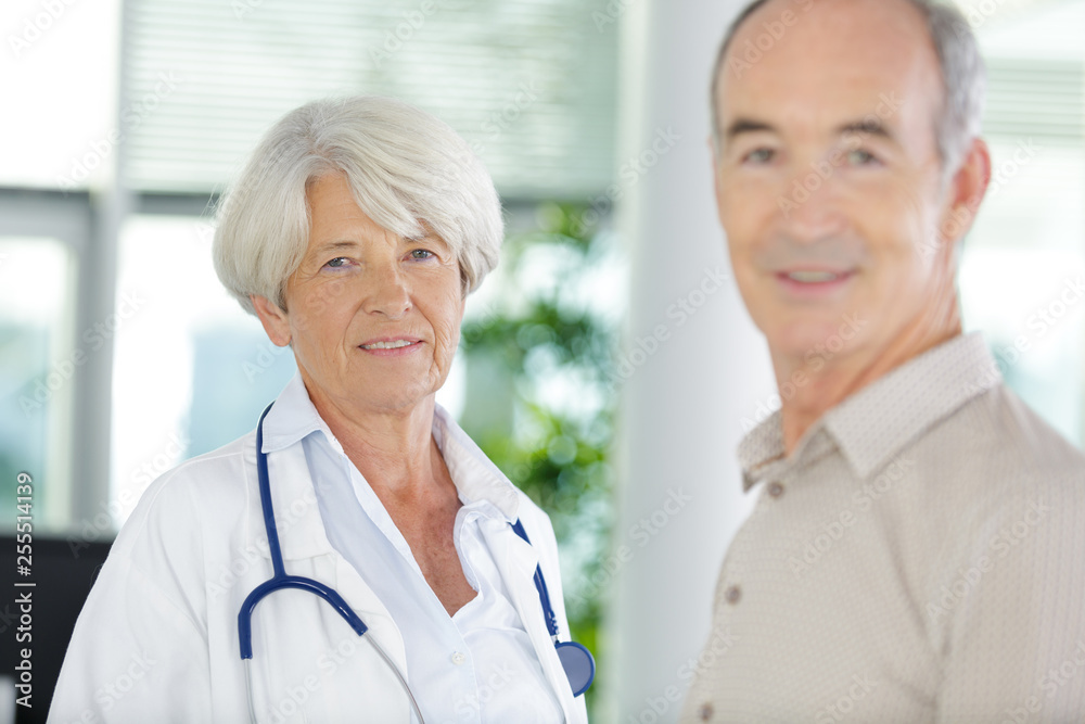 senior doctor and patient looking at camera senior doctor and patient looking at camera