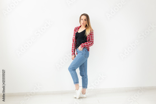 People and fashion concept - Portrait of attractive woman in plaid shirt over white background