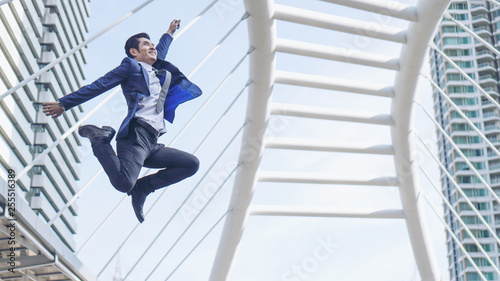 lifestyle business man feel happy jumping in air celebrating success and achievement on business district , business concept
