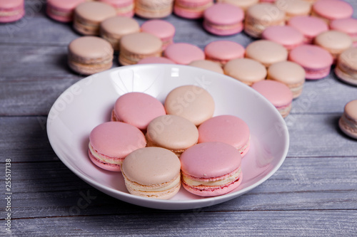 French colorful macarons background, close up macaron or macaroons cookie, tasty dessert. food background Plate of fresh colorful macarons