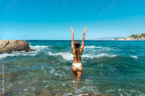 Sexy young woman in the ocean posing