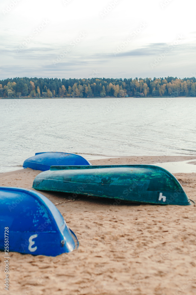 Three boats on the sandy river bank. Forest in the background. Three boats on the sandy river bank. Forest in the background.