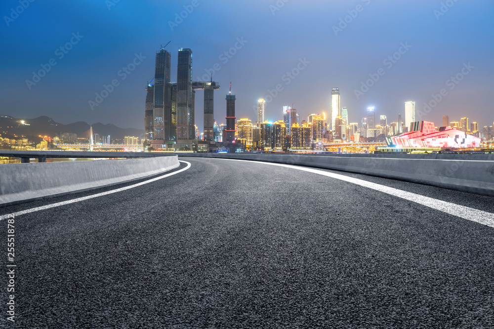 The expressway and the modern city skyline are in Chongqing, China.