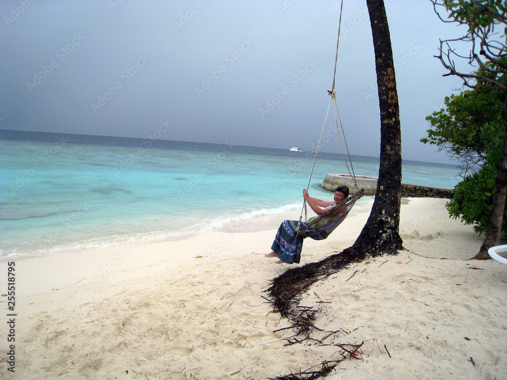 Fototapeta premium woman on swing on tropical beach