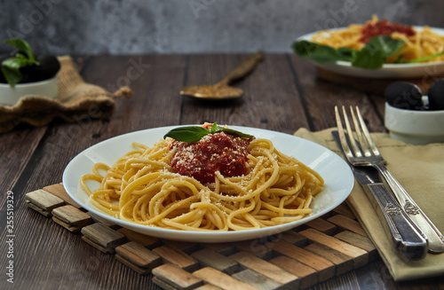 Tasty colorful appetizing cooked spaghetti italian pasta with tomato sauce bolognese and fresh basil. 