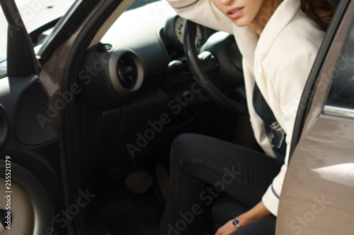Beautiful girl sitting behind wheel inside car © Embrace of Beauty