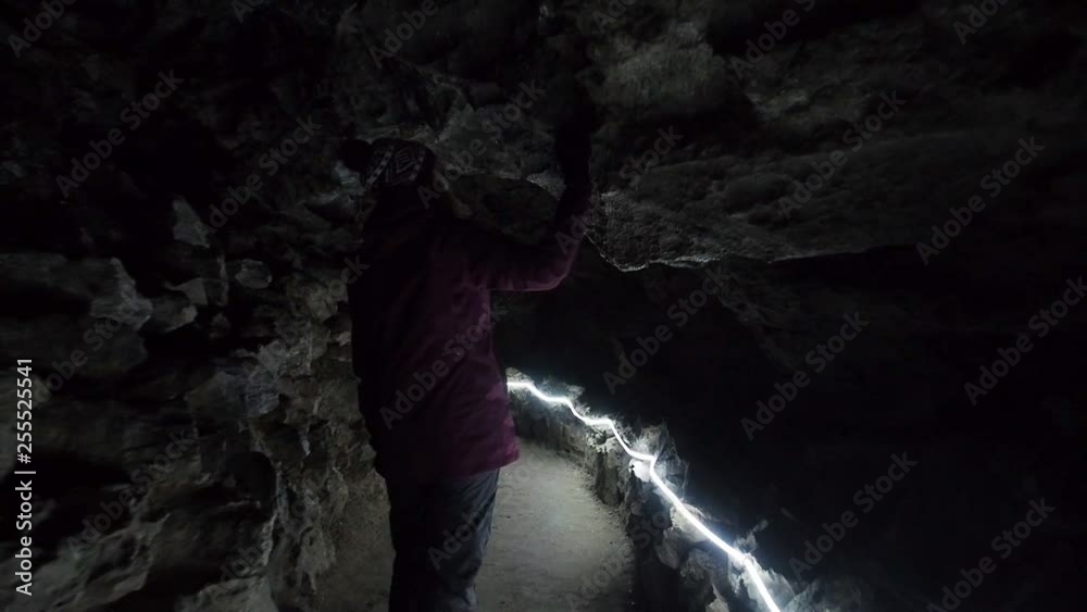 Hiker Woman Exploring Dark Mysterious Ice Cave In Winter. Explore Earth People Nature Travel Concept. Hiker Girl Hiking Enjoying Travel Vacation Outdoor Hiker Woman Exploring Dark Mysterious Ice Cave In Winter. Explore Earth People Nature Travel Concept. Hiker Girl Hiking Enjoying Travel Vacation Outdoor