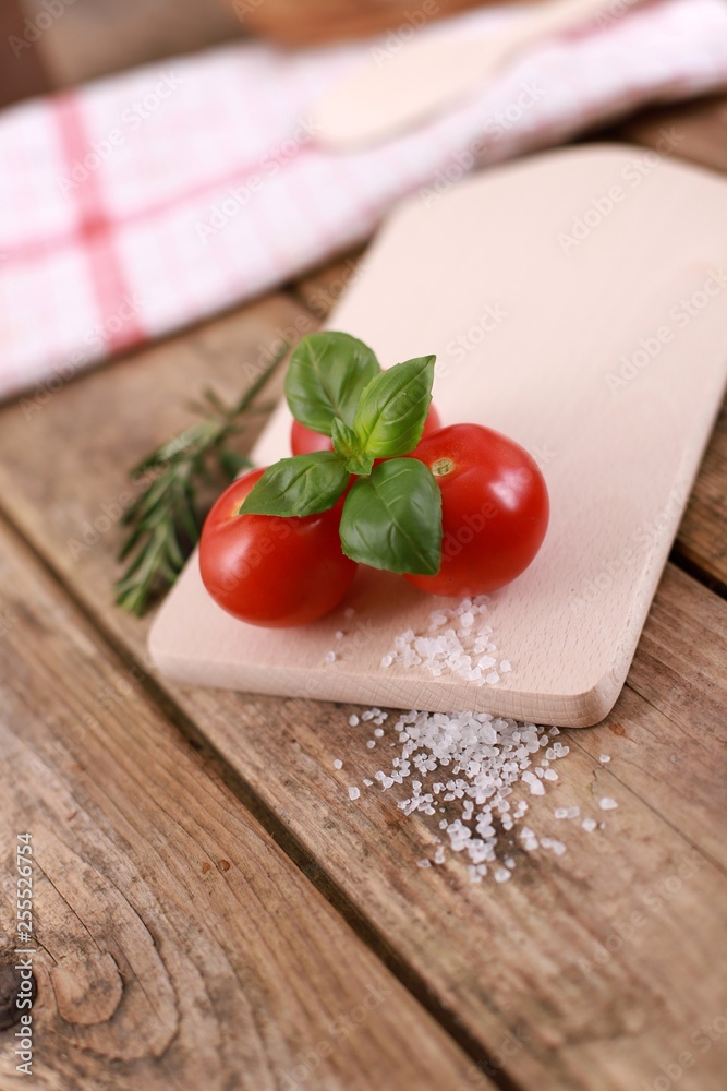 fresh tomatoes with basil and salt on a rustic wooden table - healthy breakfast fresh tomatoes with basil and salt on a rustic wooden table - healthy breakfast