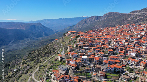 Aerial drone photo from famous and picturesque village of Arachova built on the slope of Parnassus mountain with traditional character at spring, Voiotia, Greece photo