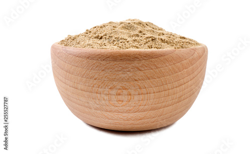 cardamon powder in wooden bowl isolated on white background. Spices and food ingredients.