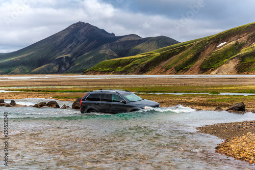 Car crossing Jokulgilskvisl river flow in Fridland ad Fjallabaki Natural park in Highlands of Iceland © sasha64f