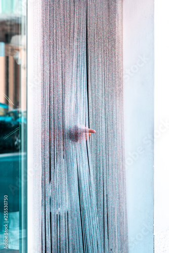 A streetshot of a man leaving a fishmarket while poitning somewhere photo