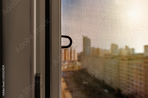 Open window with a mosquito screen to prevent insects and bugs, like flies, bees, mosquitoes or wasps from entering