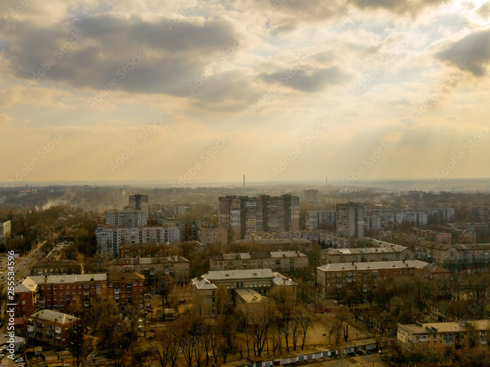 Aerial view of sun light over building roof in city from above. Outdoor cityscape. (Dnepr, Dnepropetrovsk, Dnipropetrovsk). Ukraine Aerial view of sun light over building roof in city from above. Outdoor cityscape. (Dnepr, Dnepropetrovsk, Dnipropetrovsk). Ukraine