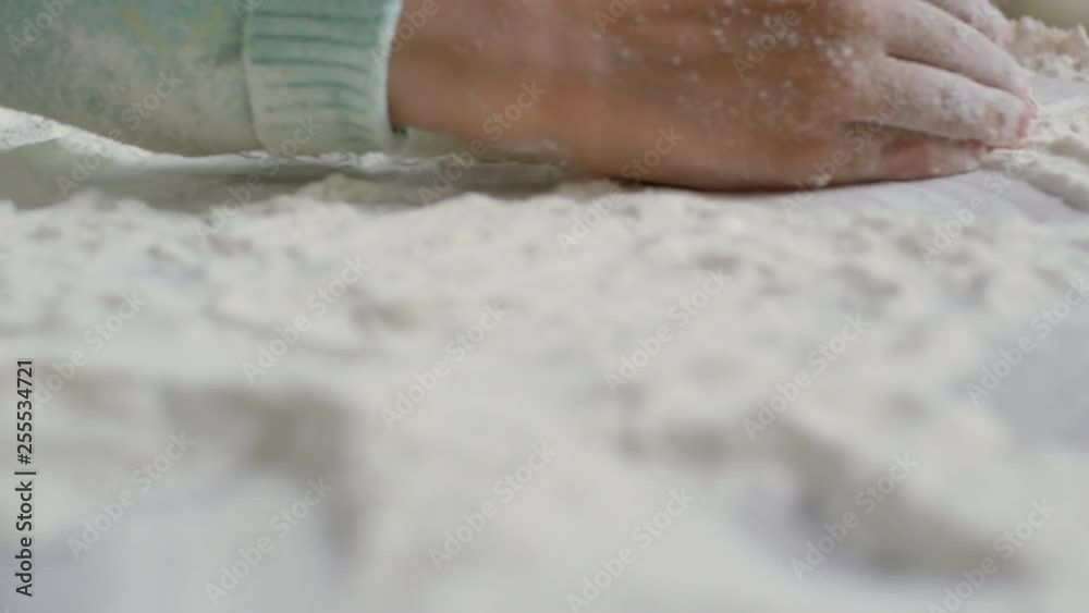 Extreme close up shot of two unrecognizable little children playing with flour while learning to cook in kitchen Extreme close up shot of two unrecognizable little children playing with flour while learning to cook in kitchen