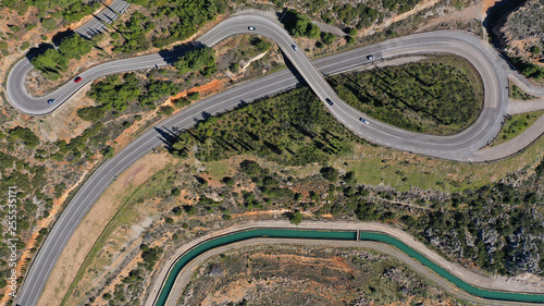 Aerial drone top view photo of snake curvy road built in steep mountain slope