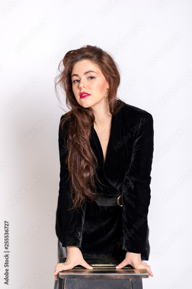 Beautiful elegant sexy brunette diva woman portrait in black clothes on the white background Beautiful elegant sexy brunette diva woman portrait in black clothes on the white background