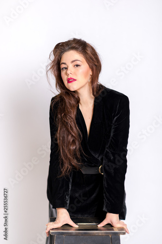 Beautiful elegant sexy brunette diva woman portrait in black clothes on the white background