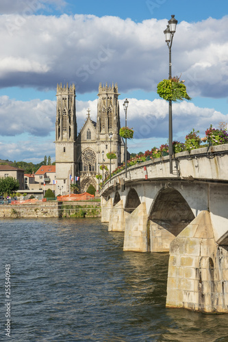 The Moselle in Pont-a-Mousson with the bridge over the river with Saint Martin's church in the background photo