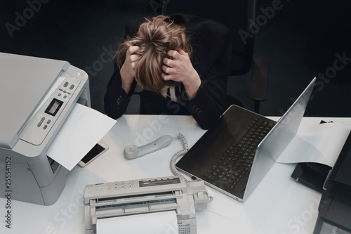 Stressed tired businesswoman feels exhausted sitting at office desk with laptop, frustrated woman can not concentrate having writers block, lack of new ideas or creative crisis