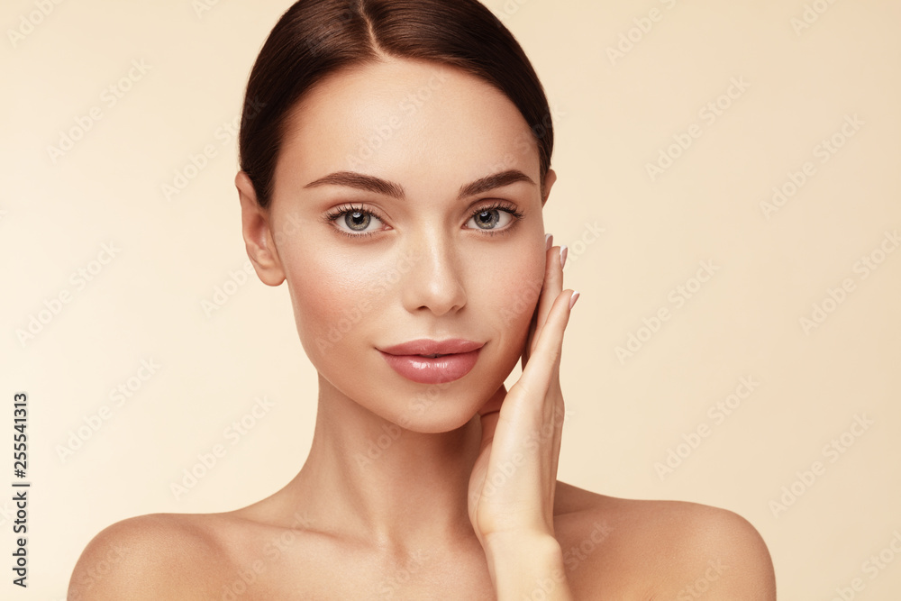 Skin care,Beauty treatment and spa concept. Attractive model with brown hair and Clean Fresh Skin touch own face Skin care,Beauty treatment and spa concept. Attractive model with brown hair and Clean Fresh Skin touch own face