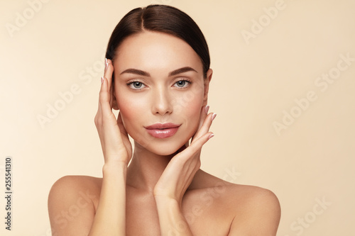 Skin care,Beauty treatment and spa concept. Attractive model with brown hair and  Clean Fresh Skin touch own face