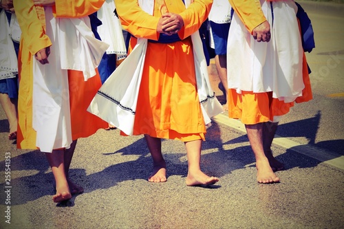 sikh men with orange clothes during religious ceremony with old