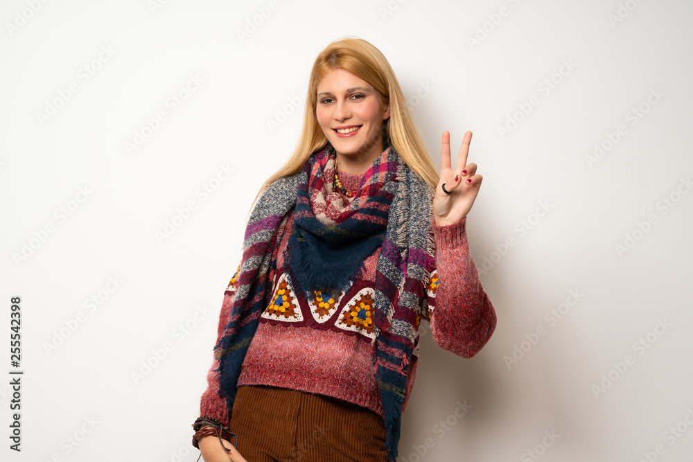 Hippie woman over white wall smiling and showing victory sign Hippie woman over white wall smiling and showing victory sign