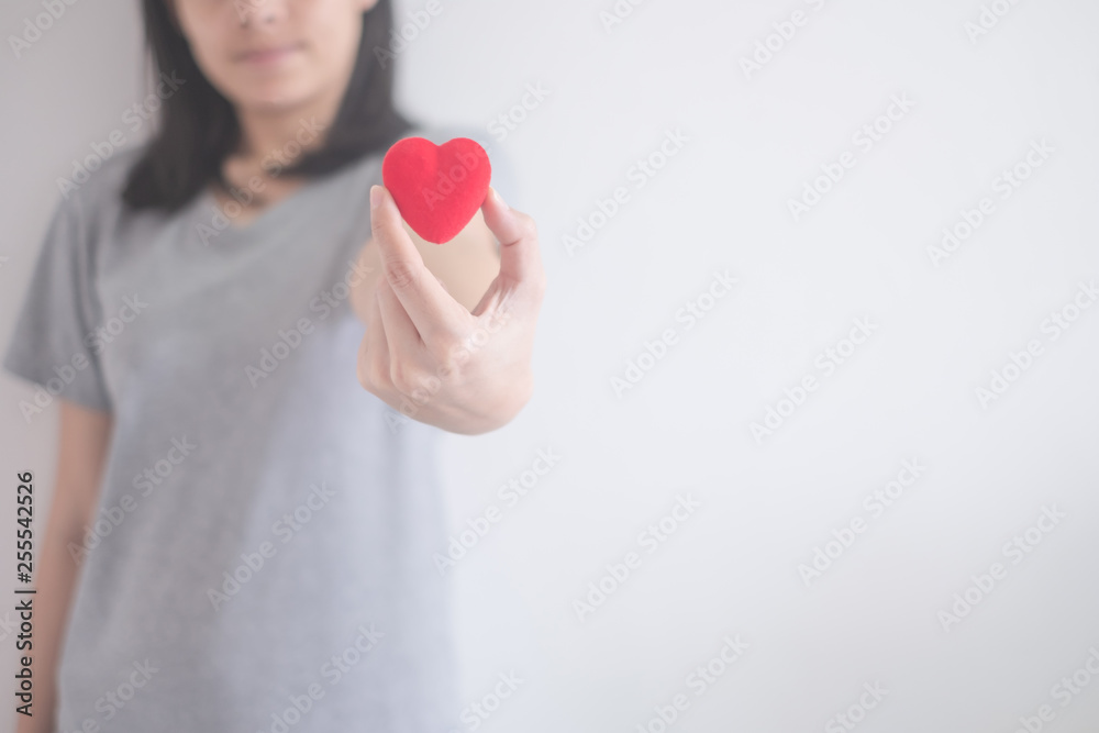 beautiful Asian woman show red heart isolated on a white background with copy space beautiful Asian woman show red heart isolated on a white background with copy space