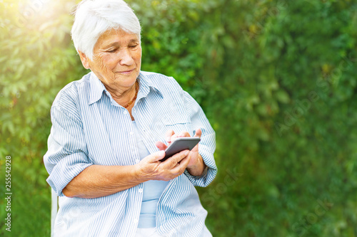 old woman talking on the phone, smartphone, smiling, call children