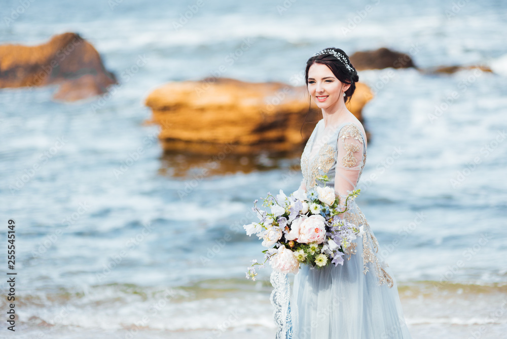 bride with a bouquet of flowers on the beach bride with a bouquet of flowers on the beach