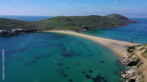 Aerial drone video of iconic two sided sandy tropical turquoise sea paradise beach of Kolones near Fykiada in island of Kythnos at spring, Cyclades, Greece photo