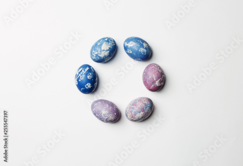 Stylish Easter layout made of colorful eggs isolated on white background.
