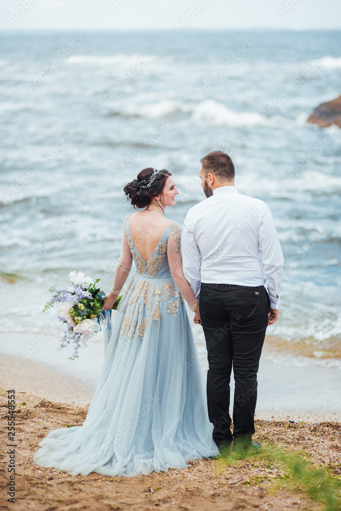 same couple with a bride in a blue dress walk same couple with a bride in a blue dress walk