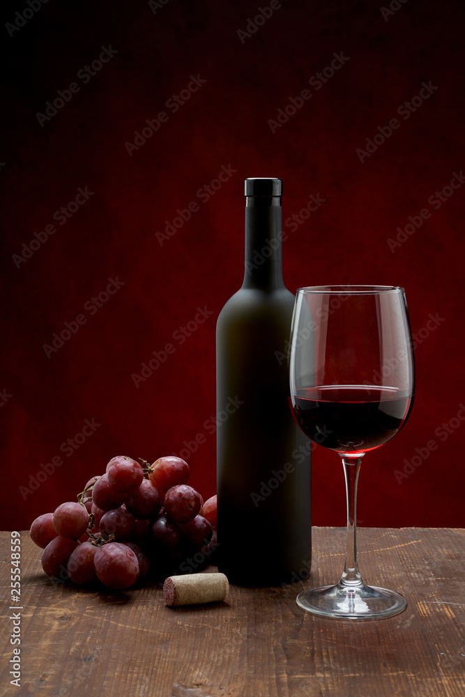 bottle of wine and glass of wine on white background