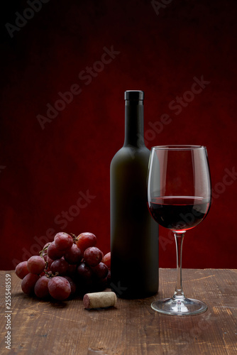 bottle of wine and glass of wine on white background