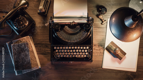 Vintage journalist desktop with typewriter and telephone