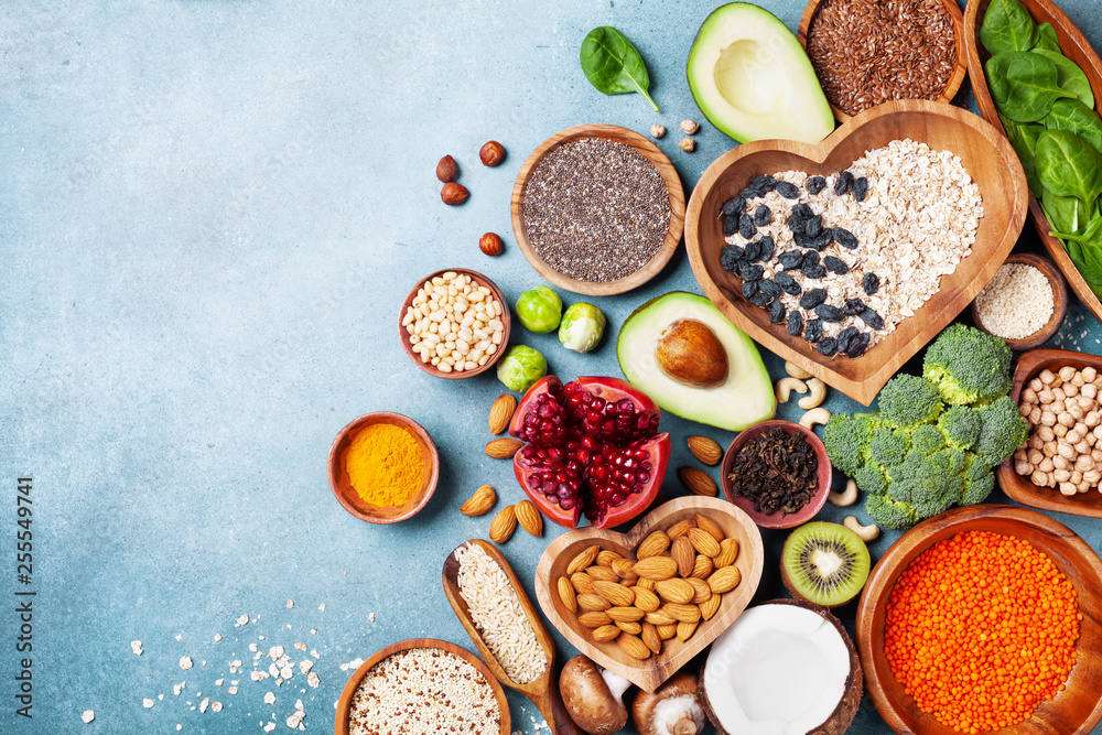 Healthy food background from fruits, vegetables, cereal, nuts and superfood. Dietary and balanced vegetarian eating products on kitchen table top view.