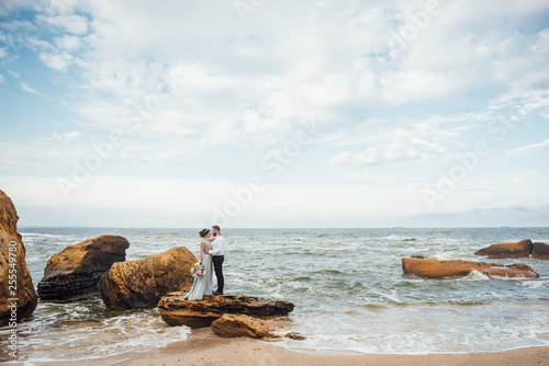 same couple with a bride in a blue dress walk