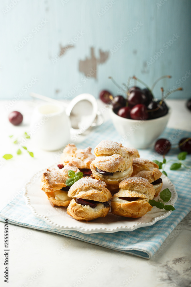 Fotografie Choux pastry buns with custard and cherry