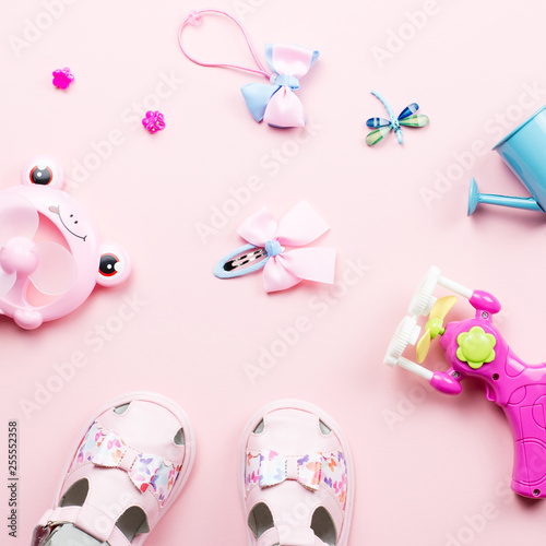 Baby girls accessories - sandals, toys. Childhood concept flat lay.